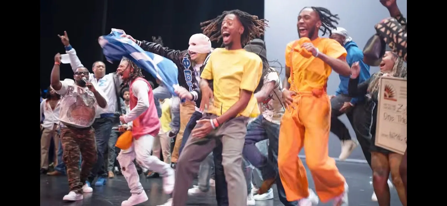 Tau Chapter brothers celebrating on stage at the step show